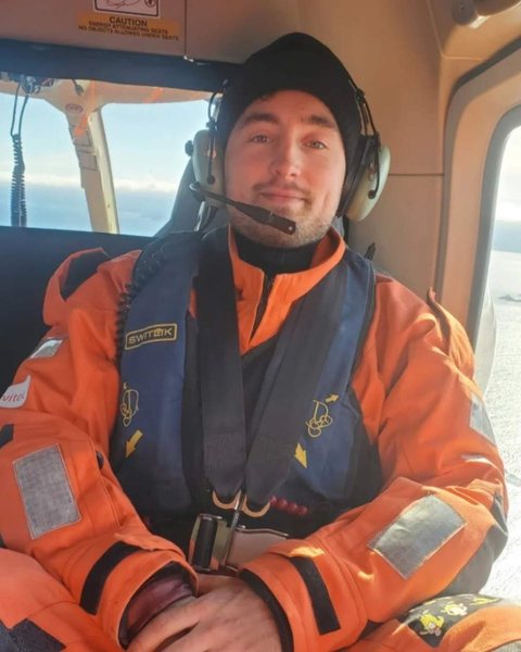 Landon Lapensee, founder of More Knocks, in a helicopter during his Coast Guard career